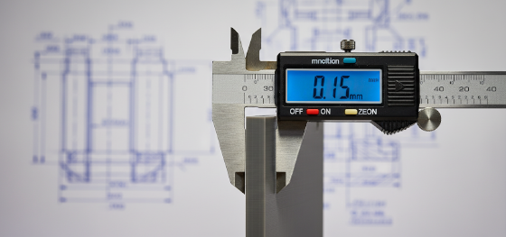 Digital caliper measuring the wall thickness of an SLA resin prototype displaying a tolerance deviation Digital caliper measuring the wall thickness of an SLA resin prototype displaying a tolerance deviation