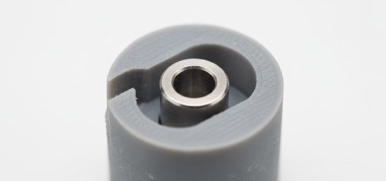 Perfectly round steel shaft sitting loosely inside an oval shaped 3D printed hole causing dimensional failure Perfectly round steel shaft sitting loosely inside an oval shaped 3D printed hole causing dimensional failure