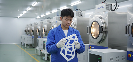 Technician inspecting an SLA master pattern next to industrial vacuum chambers in Jucheng Shenzhen Technician inspecting an SLA master pattern next to industrial vacuum chambers in Jucheng Shenzhen