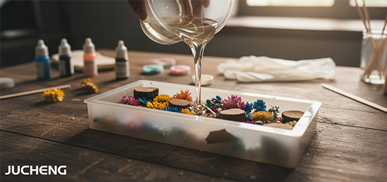 artist pouring clear epoxy resin