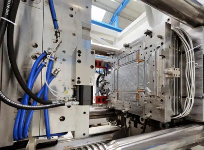 Molten plastic encapsulates the insert, bonding securely as it cools.