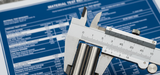 Vernier calipers measuring 1018 and 1045 cold-drawn steel bars with a material test report blueprint_